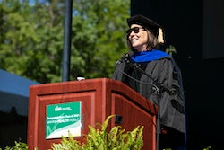 Dean Germaine Louis addresses 2021 and 2020 graduating classes during the in-person celebration.