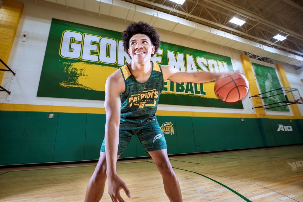 Freshman point guard Mike Gray dribbles a basketball on the court.