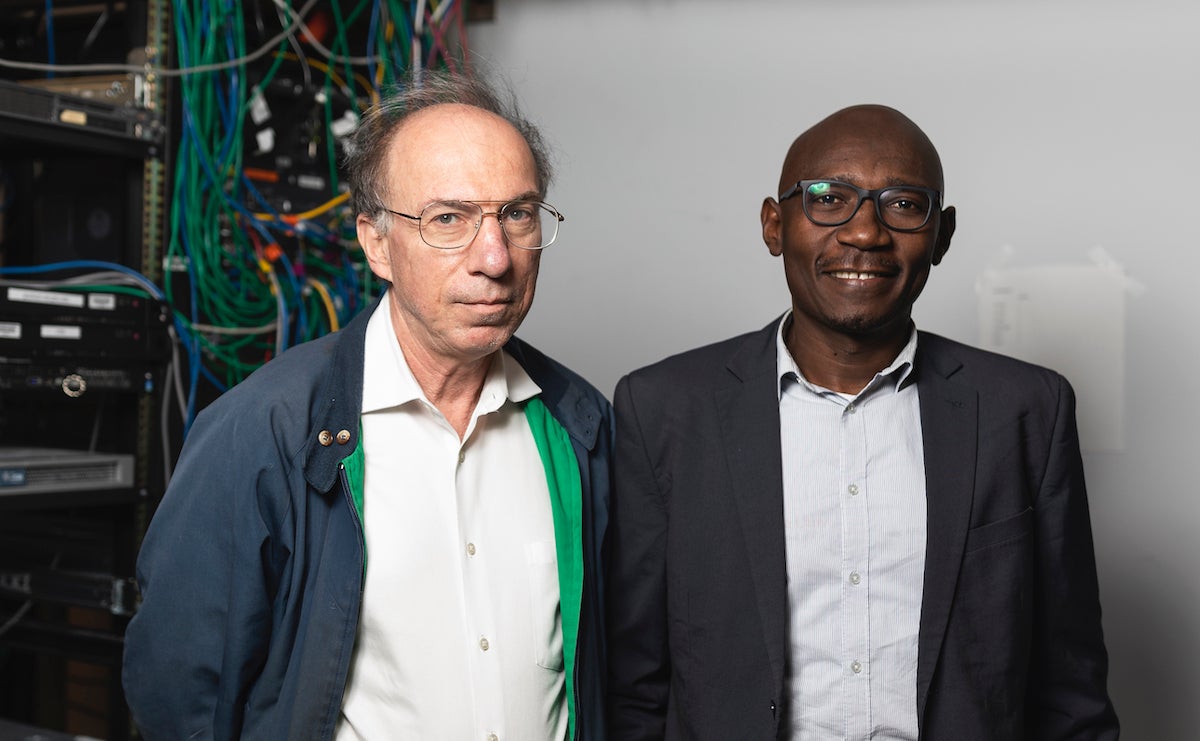 Mason's J. P. Auffret with Serge Adouaka on the Fairfax Campus during Adouaka's visit to Mason in 2019. Photo by Lathan Goumas/Strategic Communications