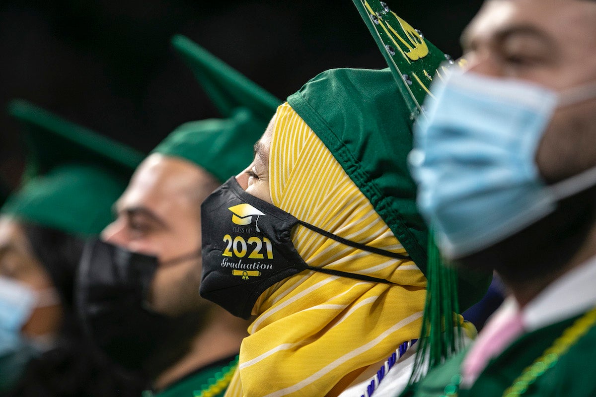 people in caps and gowns at graduation