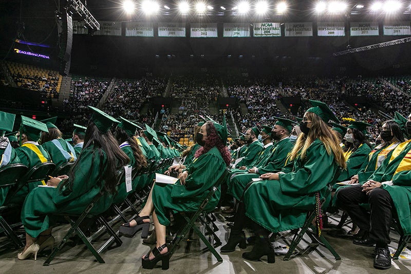 graduates in chairs at graduation
