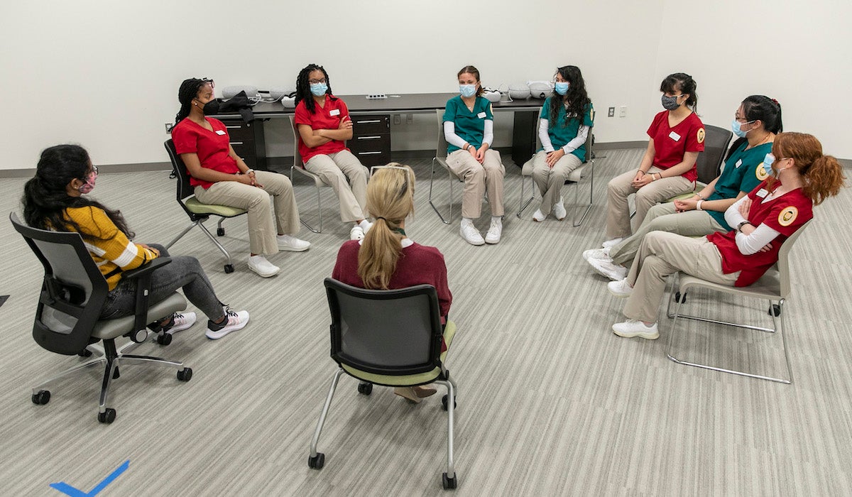students sit in a circle