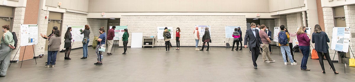 students presenting research in auditorium