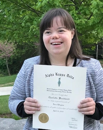 Charlotte holds an honor society certificate