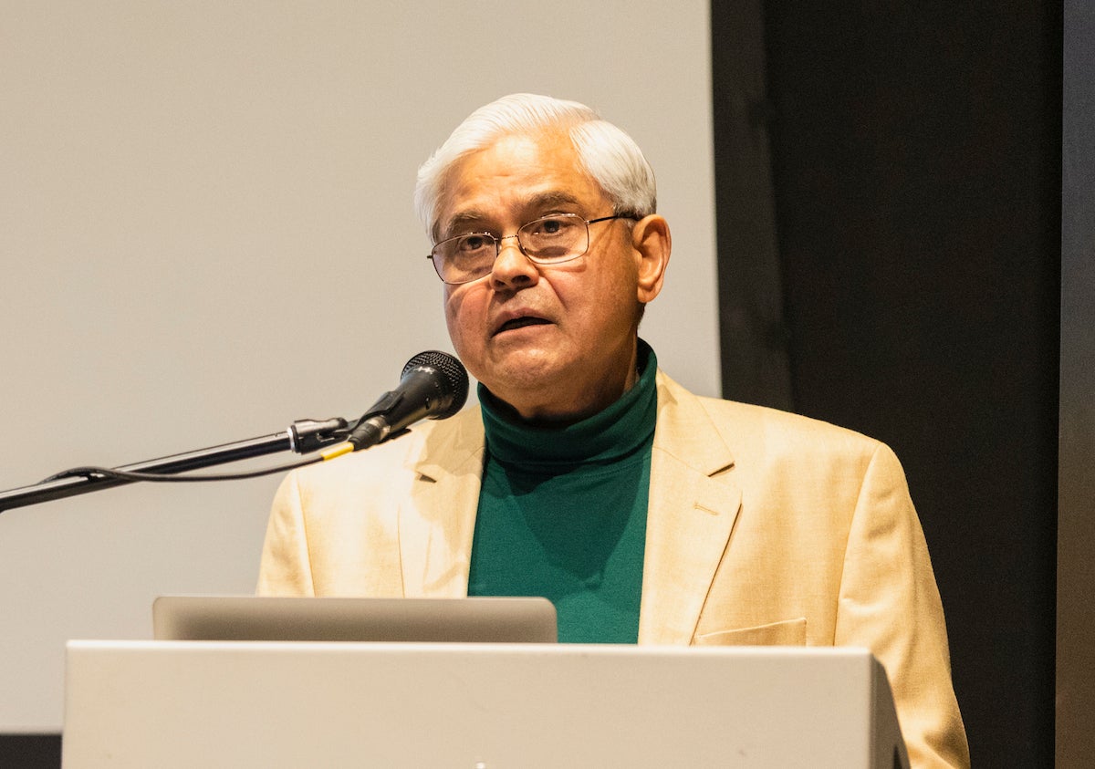 man with glasses at a podium