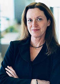 woman outside leaning against wall