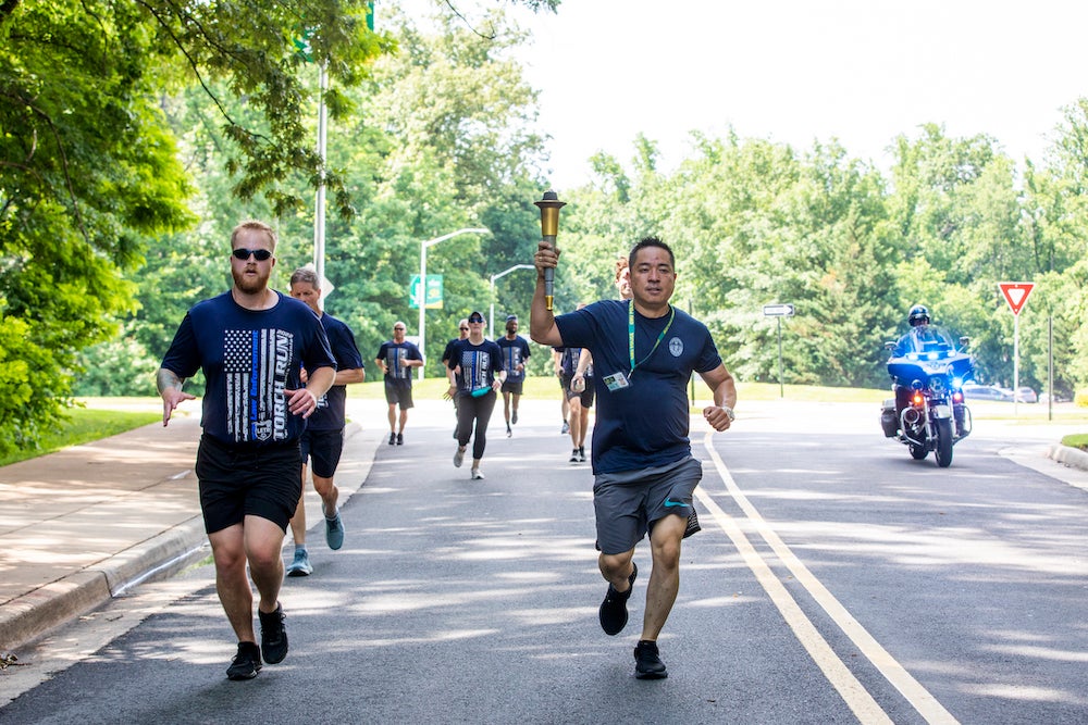 men in blue shirts running outside