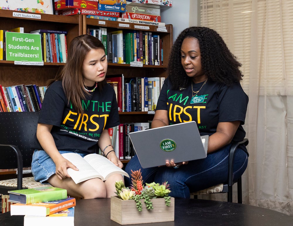 woman and a student look at a laptop