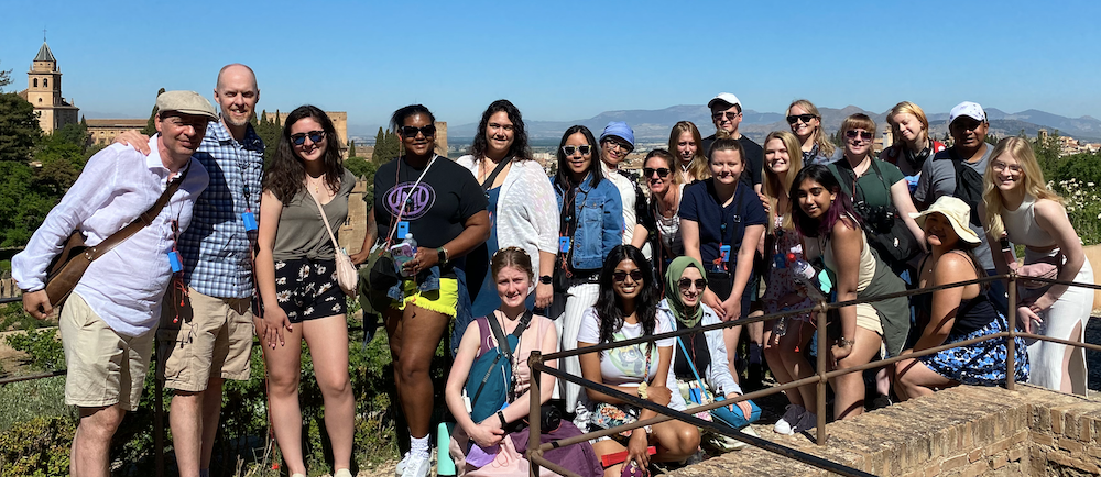 group of students posing before a landscape in Spain