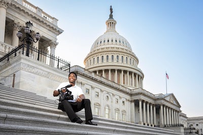 man sitting on the steps of the us capitol