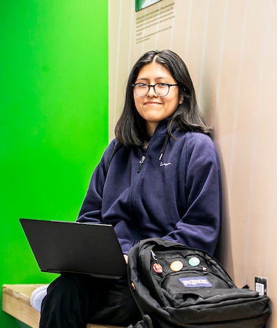 young woman sitting with laptop