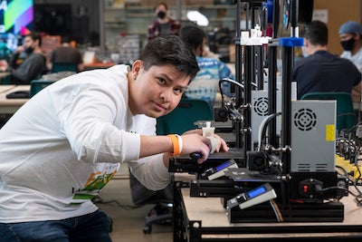 student uses 3d printer in the MIX