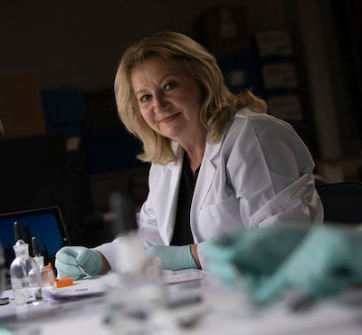 woman in white coat in her lab