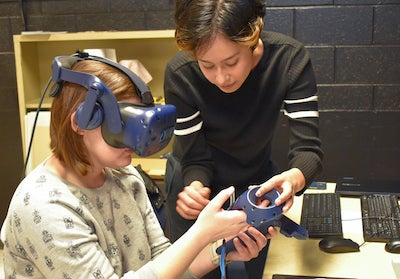 woman in VR headset with student