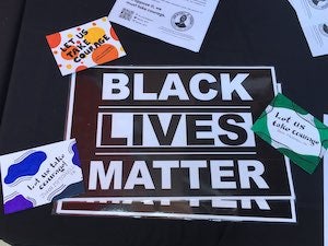 Members of JMJP post "Let us take courage," a quote from John Mitchell, Jr. on persevering in the struggle for civil rights, with signage at the March on Washington 2020. Photo provided.
