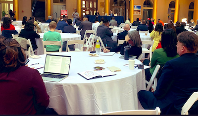 people at tables at a conference