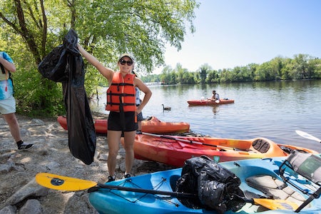 students clean up trash at Occoquan Regional Park using kayaks