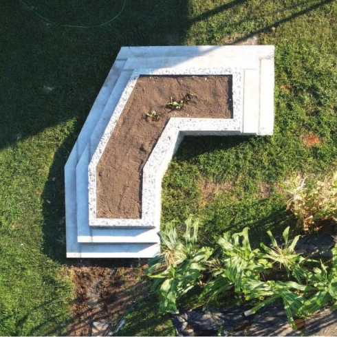 This alternative monument consists of raised community garden beds made from tabby– a material bulletproof by nature and made from a mixture of lime, sand, and water historically used by enslaved Africans as a substitute for concrete. 