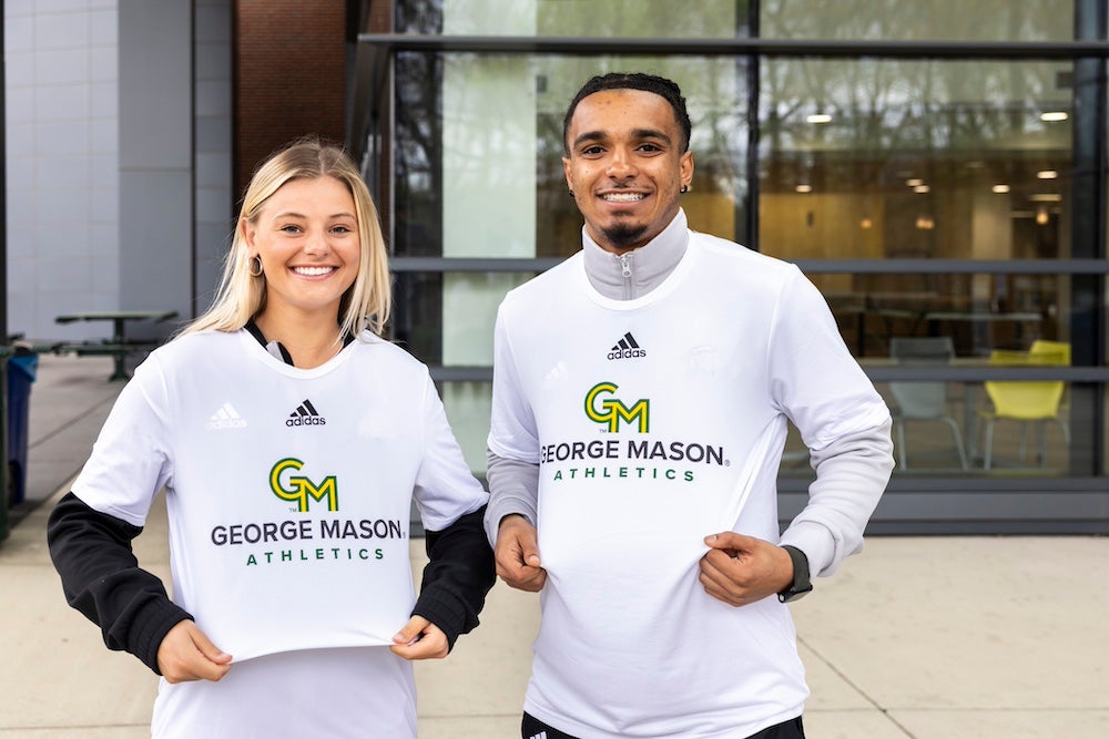 two student-athletes in new uniforms