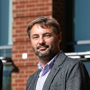 Janusz Wojtusiak in front of a building
