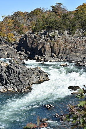 A rushing river flows between rocky cliffs.