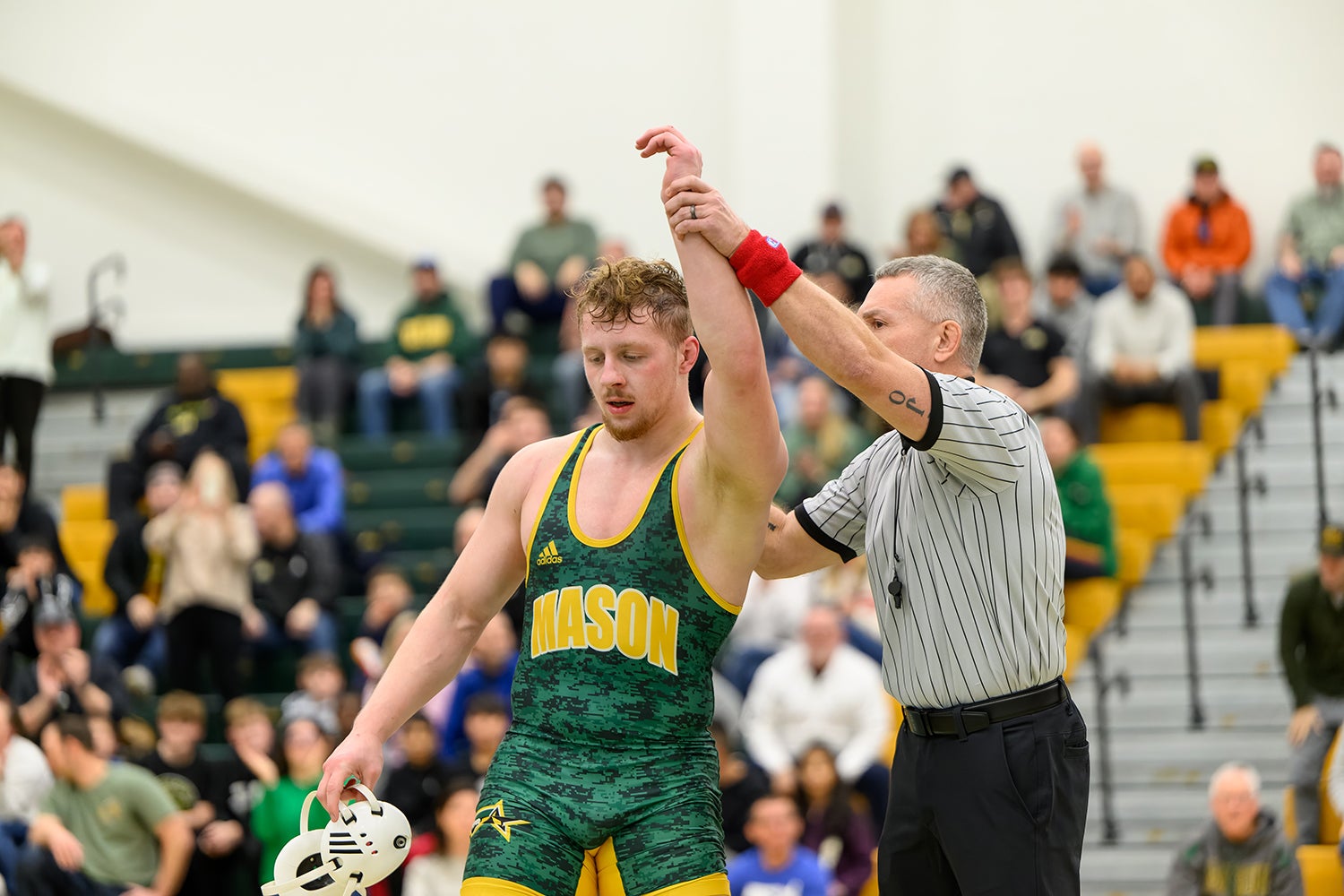 Kocak with his arm raised by a referee, declaring victory in one of his matches