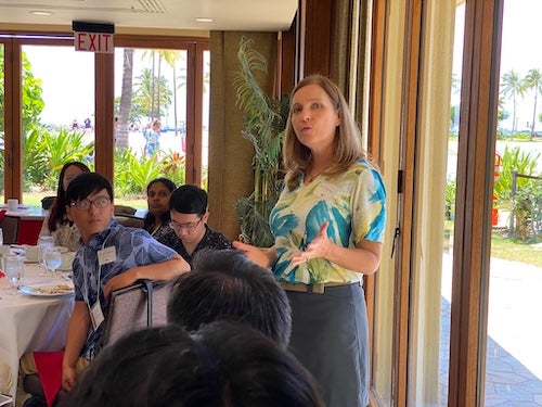 Jane Walker speaking and standing in a room of seated students