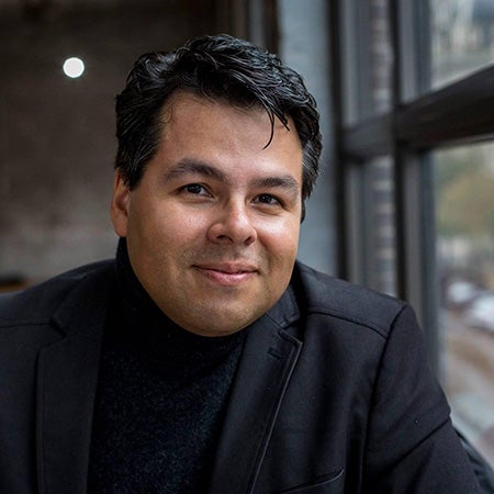 Headshot of smiling Diego Osorio in professional attire