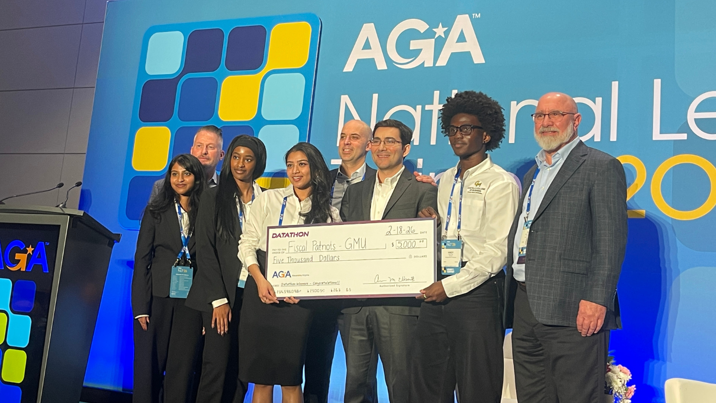 Fiscal Patriots receive the first-place prize check at Datathon. Courtesy of Fiscal Patriots.