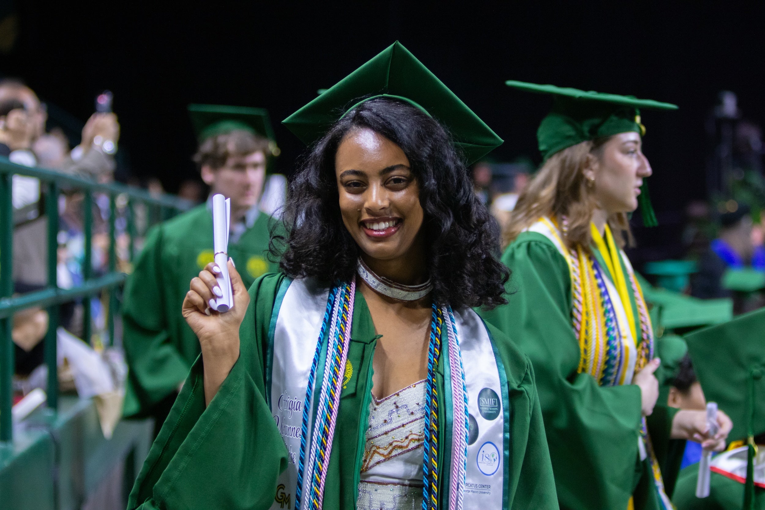 Costello College of Business graduate holding their diploma. Photo by Hannah Patterson/Costello College of Business.