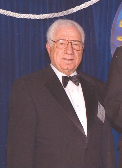 Alan standing with Senator Mitchell at the National Press Club in Washington DC