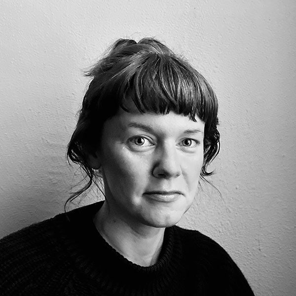 Black and white photo of Jenny with hair up and dark sweater