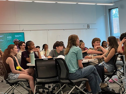 Students seated listening to an instructor