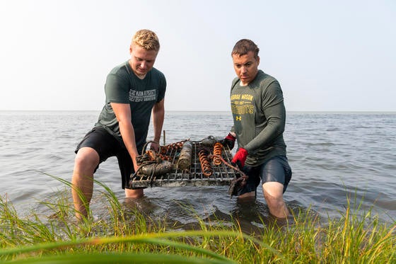 Associate professor Celso Ferriera and graduate student lift sensor out of the water