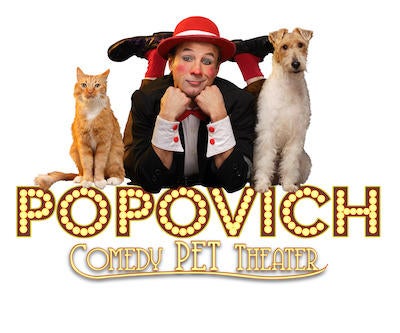 Gregory Popovich posing with a circus cat and dog, both of which are rescued.