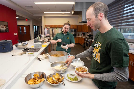 Marcus Brick (left) and Mark Radish prepare a meal for local firefighters. Photo by Evan Cantwell/Creative Services.