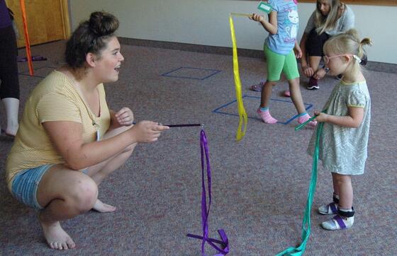 Bates working with a child in occupational therapy.