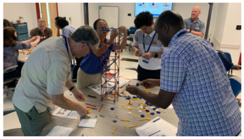 Faculty take part in a hands-on building activity 