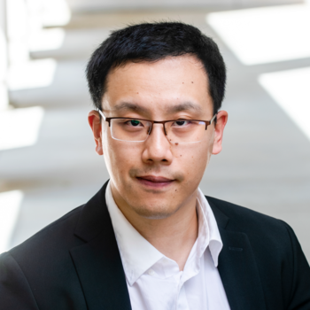 George Mason University’s Xuesu Xiao wearing black glasses and suit