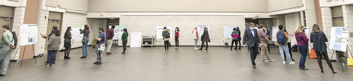 students presenting research in auditorium