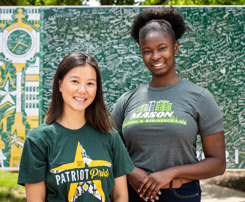 two young women outside on campus