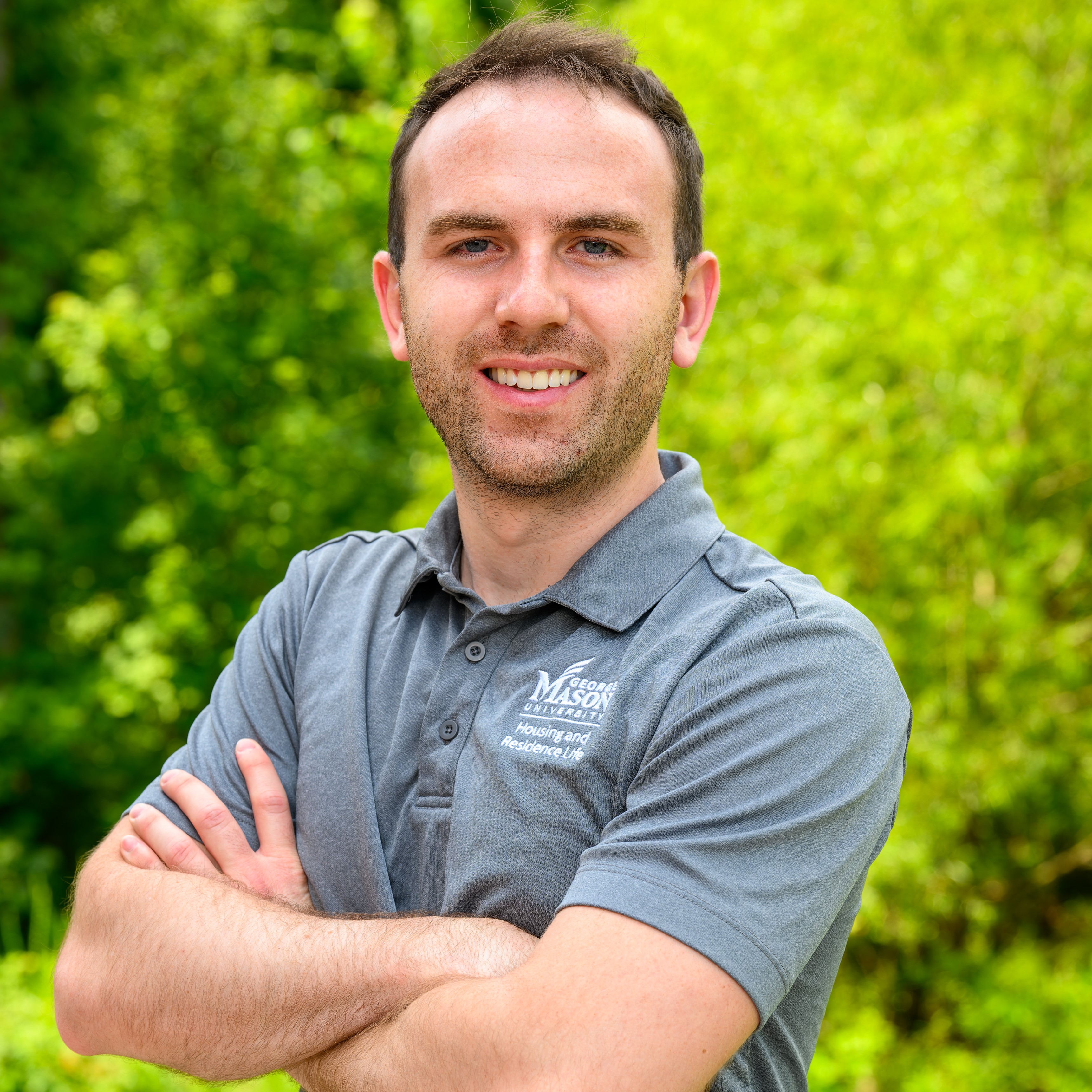 Ramon Muller in grey mason polo arms crossed smiling