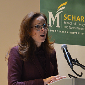 Professor Jennifer Victor stands speaking at a podium.