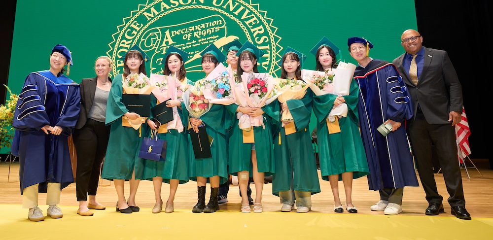 students on stage at Commencement in Mason Korea