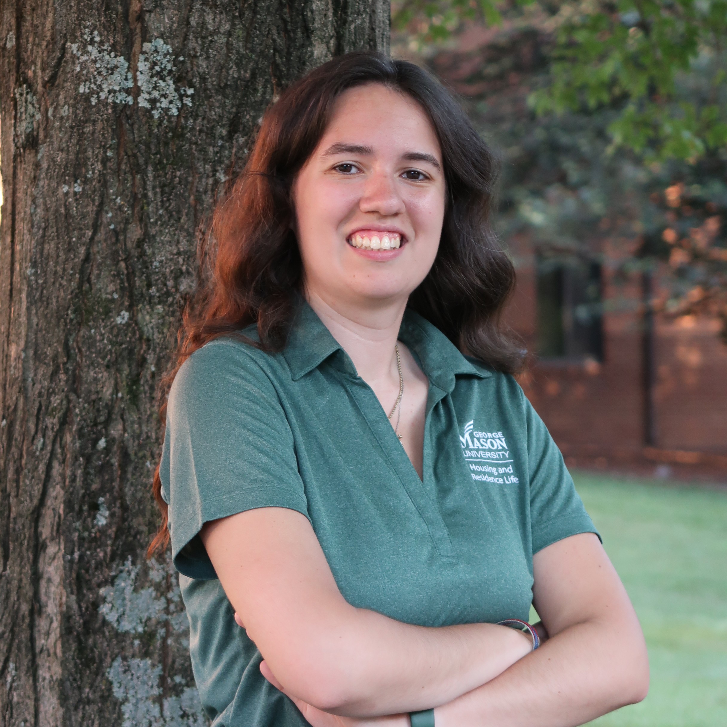 Abigail in a green mason polo smiling