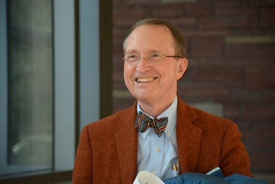 Tom Lovejoy smiles in a portrait photo, wearing a bow tie and sportcoat