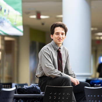 photo of Billy Bates in the Johnson Center sitting on a table
