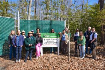 NCIS officials tour body farm with other guests.