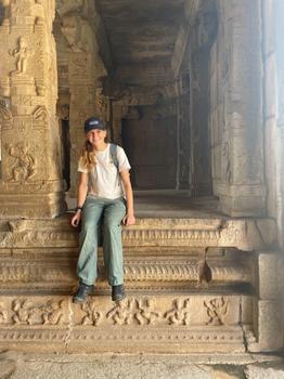Grace McIntyre sitting down at an ancient archaeological site